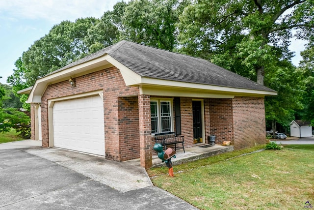 view of front of property featuring a shingled roof, brick siding, a porch, a front yard, and driveway