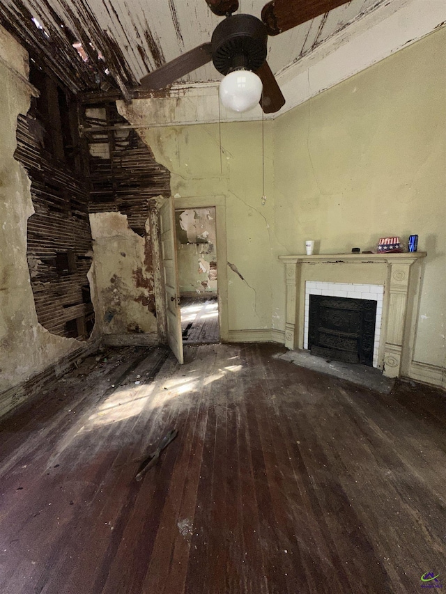 unfurnished living room with baseboards, a fireplace with flush hearth, a ceiling fan, and hardwood / wood-style flooring