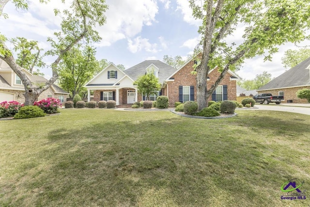 craftsman house with brick siding and a front yard