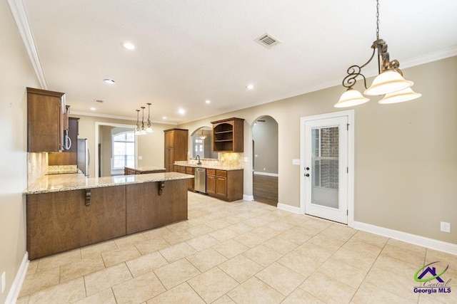 kitchen featuring open shelves, appliances with stainless steel finishes, arched walkways, and ornamental molding