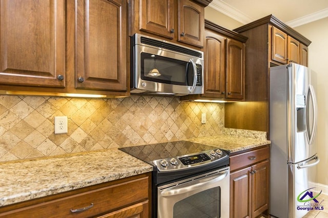 kitchen featuring light stone countertops, appliances with stainless steel finishes, ornamental molding, and tasteful backsplash