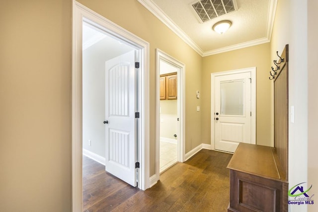 interior space featuring crown molding, baseboards, visible vents, and dark wood finished floors