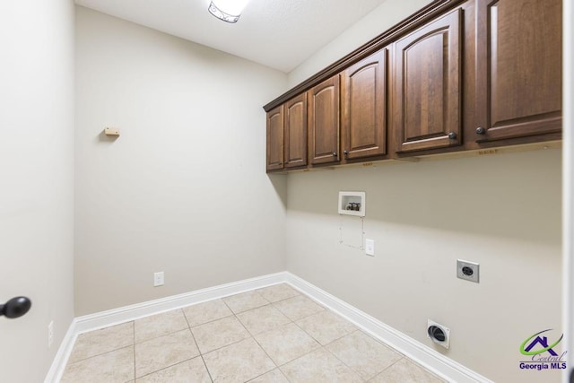 washroom featuring light tile patterned flooring, baseboards, hookup for a washing machine, electric dryer hookup, and cabinet space