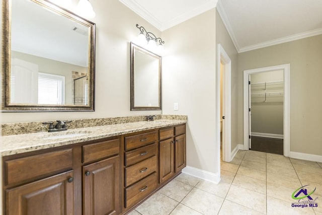 full bathroom featuring crown molding, a sink, baseboards, and double vanity