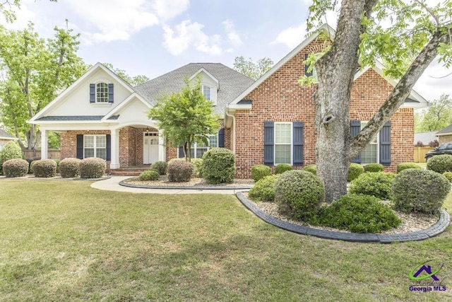 craftsman inspired home featuring brick siding, a front lawn, and covered porch