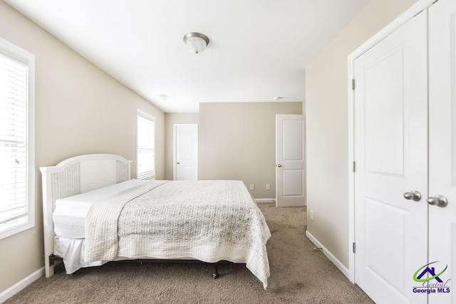 bedroom with baseboards and carpet flooring
