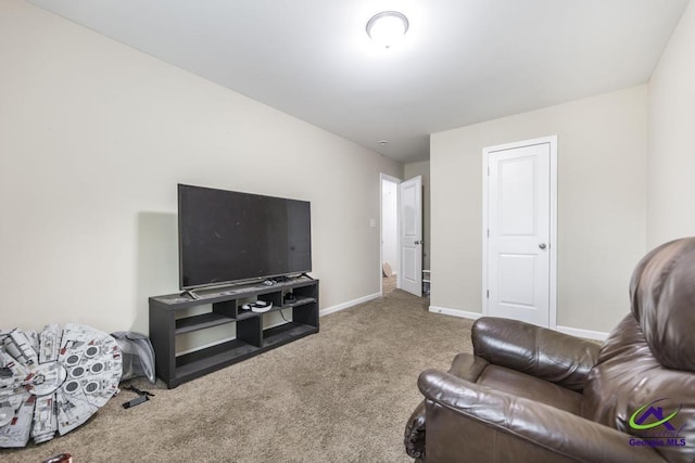 carpeted living area featuring baseboards