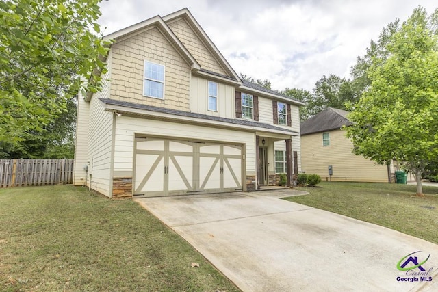 craftsman-style home with board and batten siding, fence, a front lawn, concrete driveway, and an attached garage