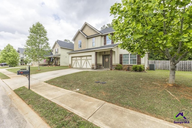 craftsman house with a front lawn, fence, stone siding, concrete driveway, and an attached garage