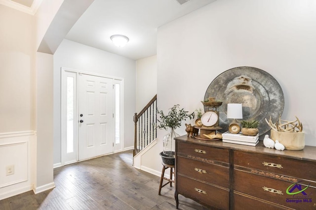 entrance foyer featuring stairs, baseboards, dark wood finished floors, and crown molding
