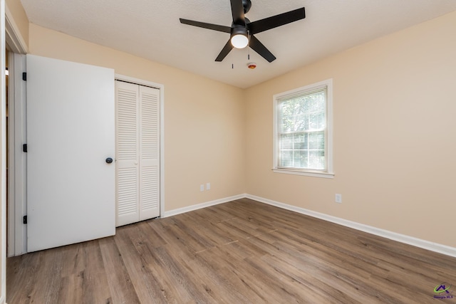 133 Avalon Dr, Warner Robins, GA 31093 - unfurnished bedroom with baseboards, a ceiling fan, a closet, and wood finished floors