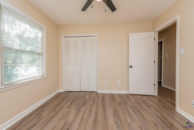 133 Avalon Dr, Warner Robins, GA 31093 - unfurnished bedroom with light wood-type flooring, baseboards, ceiling fan, and a closet