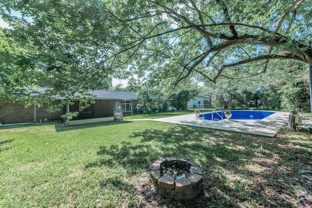 133 Avalon Dr, Warner Robins, GA 31093 - view of yard with a sunroom, a fire pit, and an outdoor pool