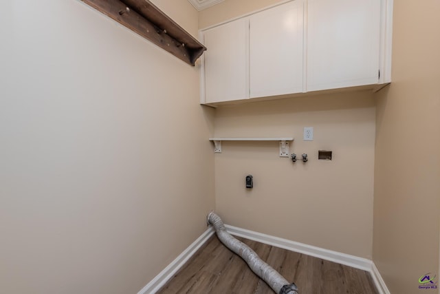 133 Avalon Dr, Warner Robins, GA 31093 - laundry room with cabinet space, hookup for a washing machine, baseboards, wood finished floors, and hookup for an electric dryer
