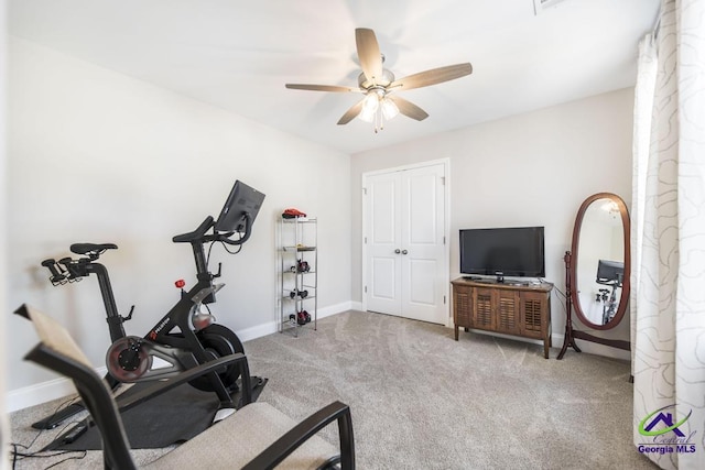 exercise room with baseboards, a ceiling fan, and carpet flooring