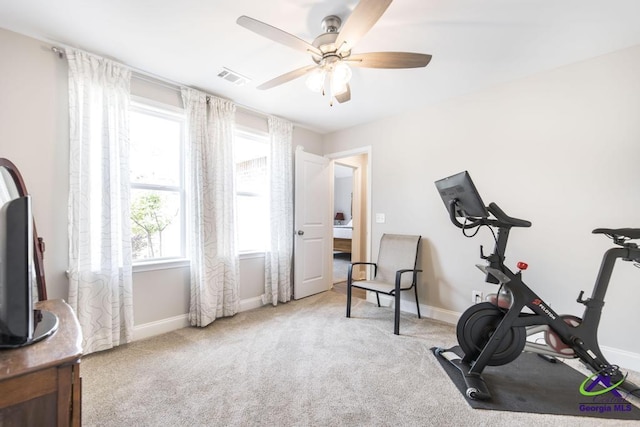 workout room with carpet floors, ceiling fan, visible vents, and baseboards