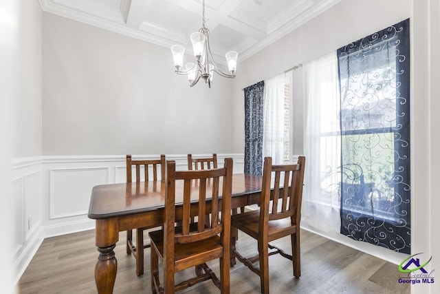 dining area featuring wood finished floors, ornamental molding, coffered ceiling, and beam ceiling