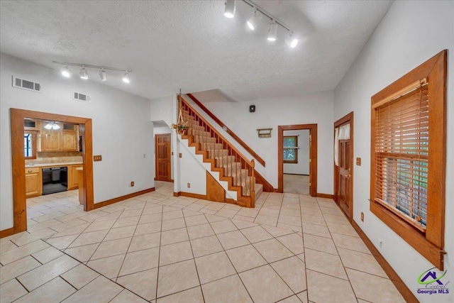 124 Joy Dr, Warner Robins, GA 31088 - entrance foyer with light tile patterned flooring, rail lighting, visible vents, and stairway