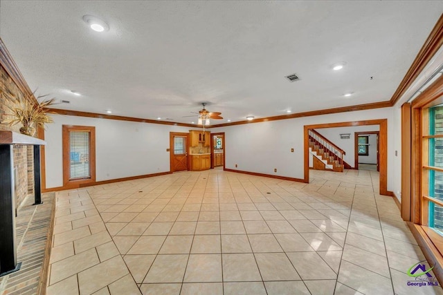 124 Joy Dr, Warner Robins, GA 31088 - interior space featuring crown molding, stairs, a fireplace, a ceiling fan, and light tile patterned floors