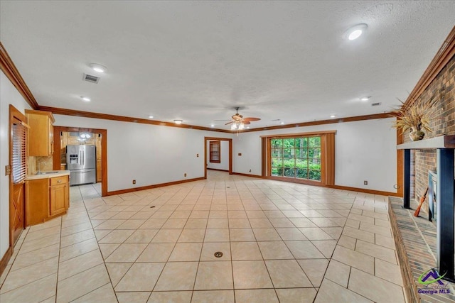 124 Joy Dr, Warner Robins, GA 31088 - unfurnished living room featuring visible vents, a ceiling fan, a brick fireplace, and crown molding