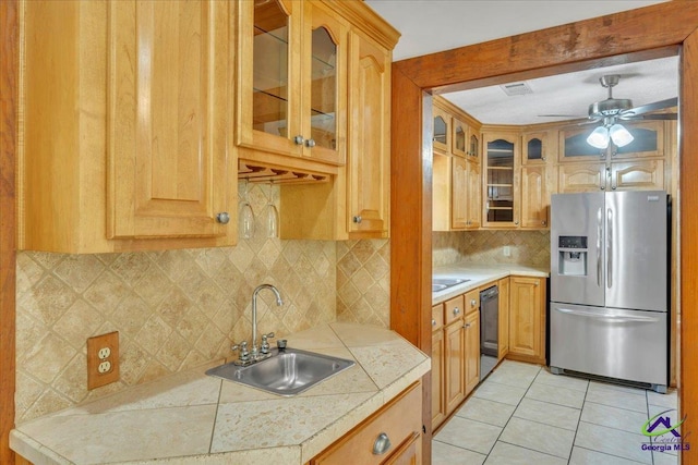 124 Joy Dr, Warner Robins, GA 31088 - kitchen featuring decorative backsplash, light tile patterned floors, a sink, stainless steel fridge, and black dishwasher