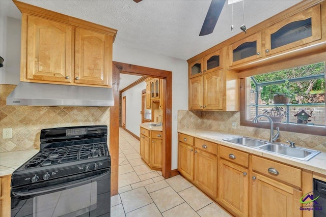 124 Joy Dr, Warner Robins, GA 31088 - kitchen with light countertops, a sink, under cabinet range hood, and black gas range oven