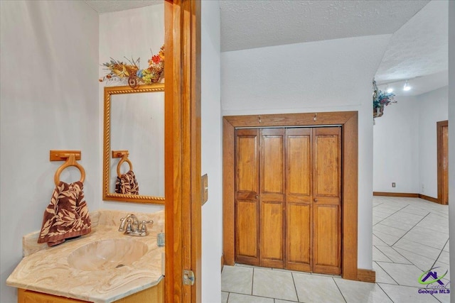 124 Joy Dr, Warner Robins, GA 31088 - bathroom with tile patterned flooring, a textured ceiling, and vanity