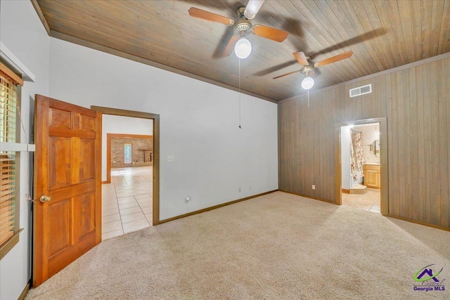 124 Joy Dr, Warner Robins, GA 31088 - unfurnished bedroom with wood walls, visible vents, wood ceiling, and carpet