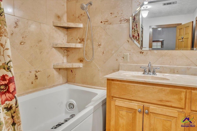 124 Joy Dr, Warner Robins, GA 31088 - bathroom featuring backsplash, visible vents, tile walls, vanity, and shower / tub combo with curtain