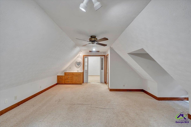 124 Joy Dr, Warner Robins, GA 31088 - additional living space featuring baseboards, light carpet, a ceiling fan, and lofted ceiling