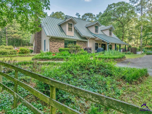 124 Joy Dr, Warner Robins, GA 31088 - view of front of house featuring a ceiling fan, brick siding, a standing seam roof, and metal roof