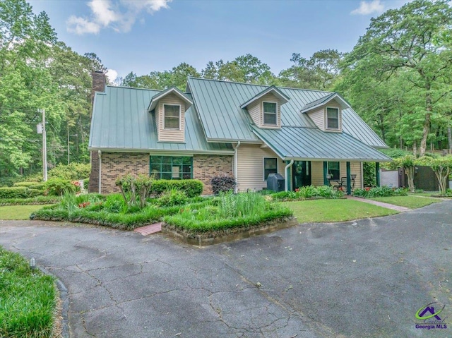124 Joy Dr, Warner Robins, GA 31088 - view of front of property featuring brick siding, metal roof, a chimney, and a standing seam roof