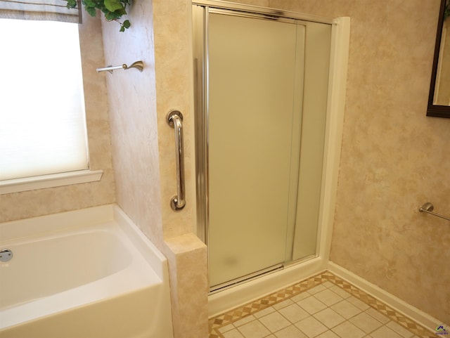 full bathroom with a garden tub, baseboards, tile patterned flooring, and a stall shower