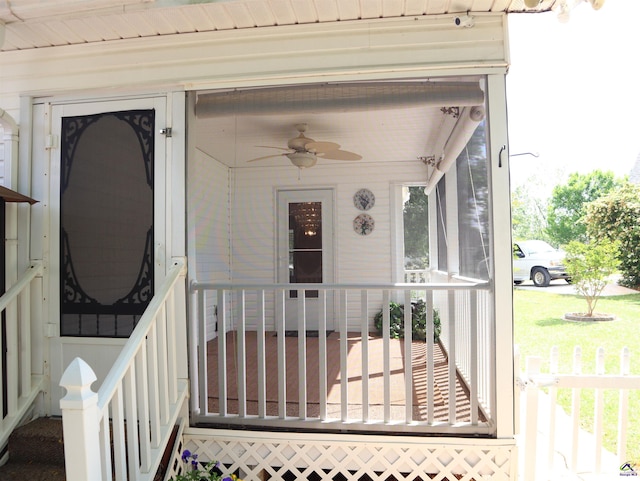 view of exterior entry with ceiling fan