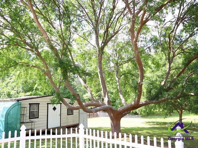 exterior space with an outbuilding and a fenced front yard