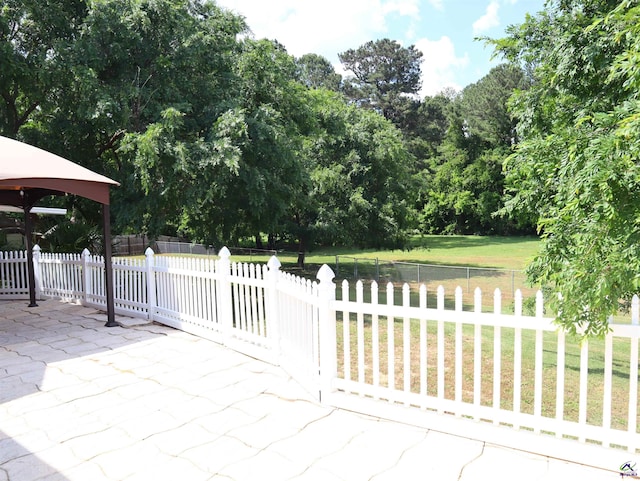 view of patio / terrace with fence and a gazebo