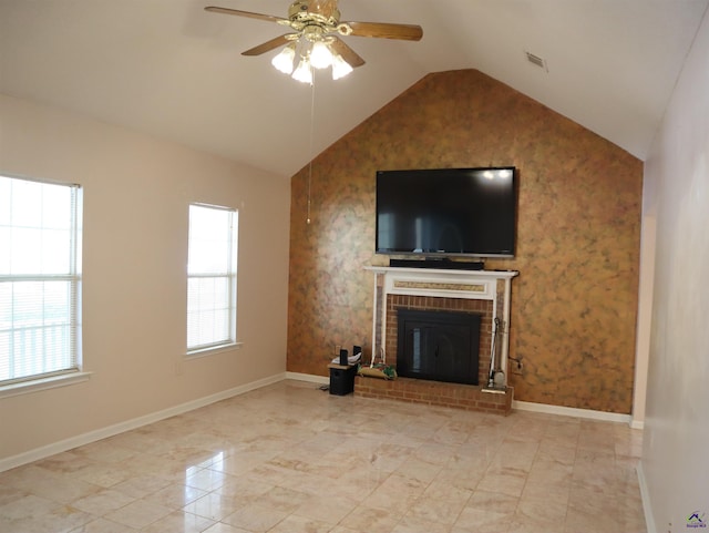 unfurnished living room with plenty of natural light, a ceiling fan, a brick fireplace, and vaulted ceiling
