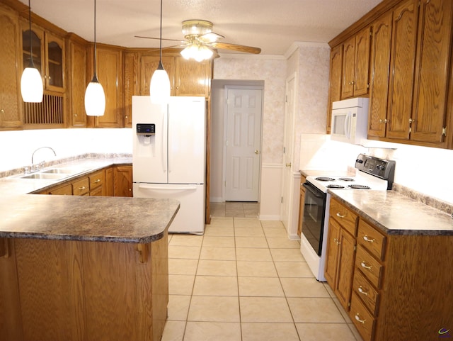 kitchen with a sink, brown cabinetry, and white appliances