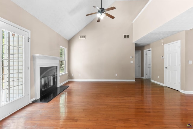 203 York Ln, Macon, GA 31220 - unfurnished living room with visible vents, a ceiling fan, a fireplace with raised hearth, and high vaulted ceiling