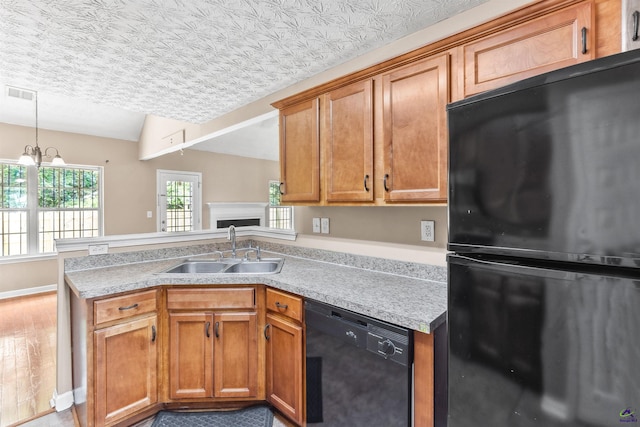 203 York Ln, Macon, GA 31220 - kitchen with visible vents, light countertops, brown cabinets, a sink, and black appliances