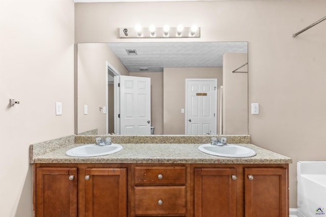 203 York Ln, Macon, GA 31220 - full bath featuring a sink, a washtub, double vanity, and visible vents