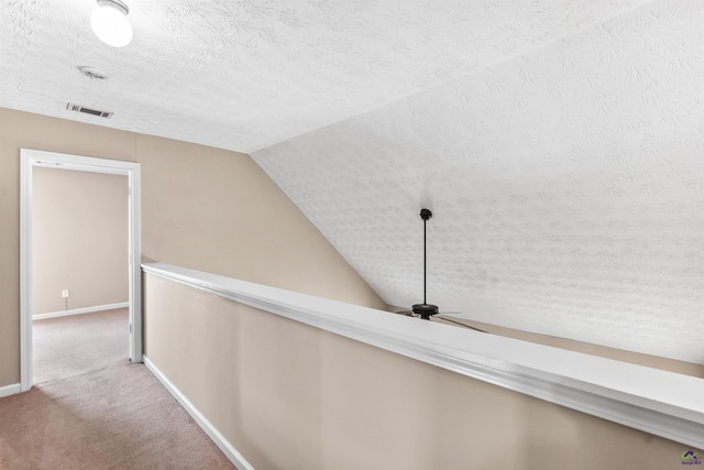 203 York Ln, Macon, GA 31220 - hallway with a textured ceiling, visible vents, baseboards, lofted ceiling, and carpet