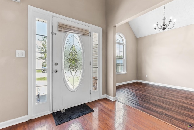 203 York Ln, Macon, GA 31220 - entryway with baseboards, a notable chandelier, vaulted ceiling, and hardwood / wood-style flooring