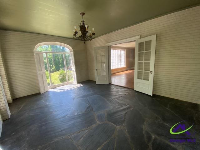 1218 Nottingham Dr, Macon, GA 31210 - unfurnished dining area with a notable chandelier, plenty of natural light, and french doors