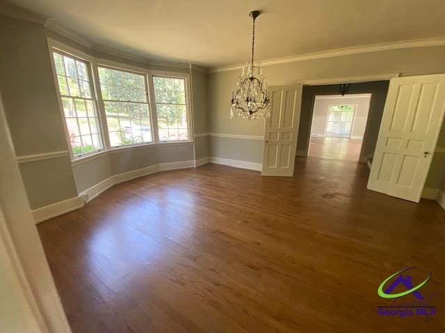 1218 Nottingham Dr, Macon, GA 31210 - unfurnished dining area featuring crown molding, baseboards, dark wood finished floors, and a chandelier