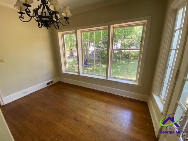 1218 Nottingham Dr, Macon, GA 31210 - unfurnished dining area featuring an inviting chandelier, baseboards, and a healthy amount of sunlight