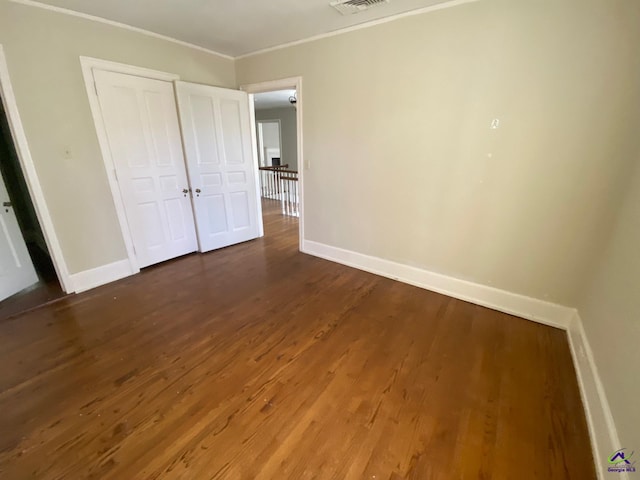 1218 Nottingham Dr, Macon, GA 31210 - unfurnished bedroom featuring crown molding, baseboards, wood finished floors, and visible vents