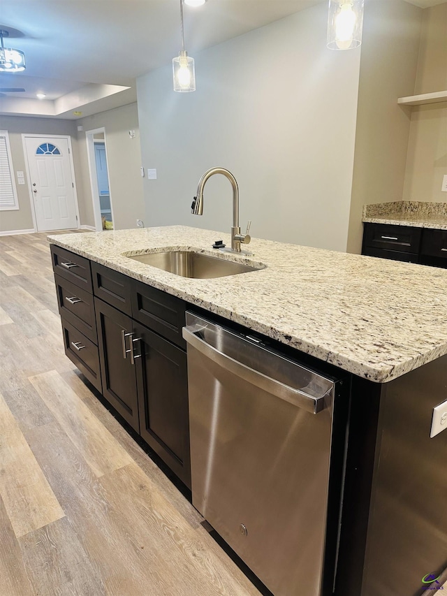 325 Peach Cir, Fort Valley, GA 31030 - kitchen featuring dishwasher, light wood-style floors, pendant lighting, light stone counters, and a kitchen island with sink
