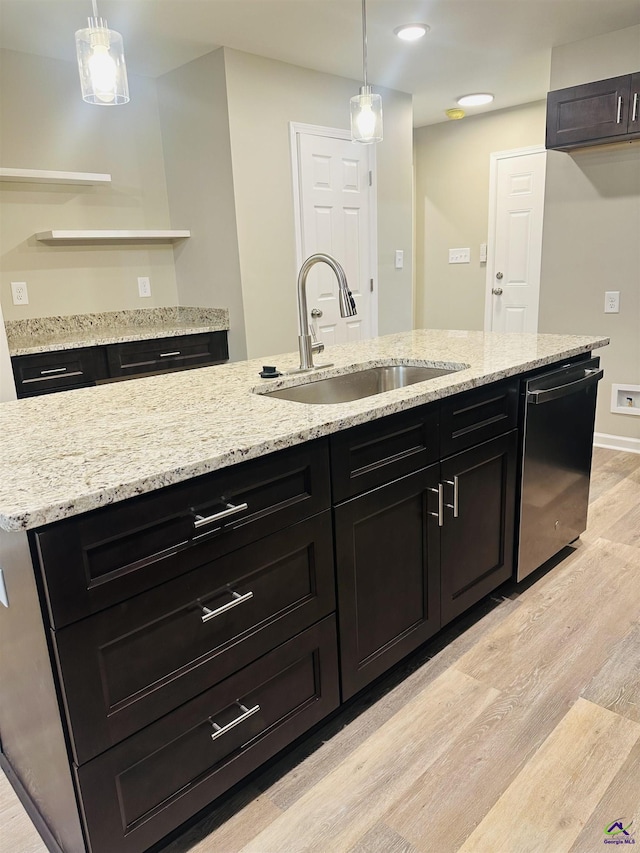 325 Peach Cir, Fort Valley, GA 31030 - kitchen with stainless steel dishwasher, light wood finished floors, hanging light fixtures, light stone countertops, and recessed lighting