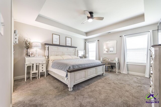 122 Milford Cir, Perry, GA 31069 - carpeted bedroom with baseboards, ceiling fan, a tray ceiling, and visible vents
